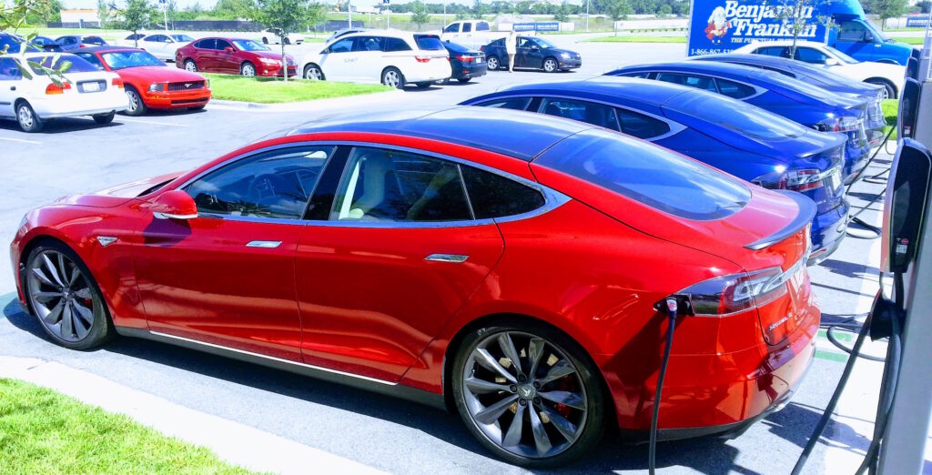 Teslas charging in outdoor parking lot