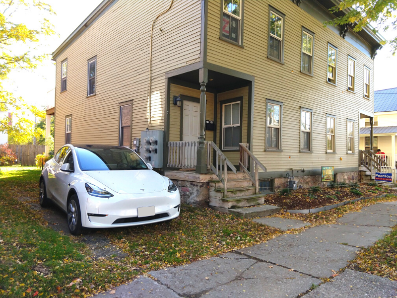 A TESLA MODEL Y CHARGES AT A PUBLICLY AVAILABLE CHARGER AT A FOURPLEX IN BURLINGTON, VT.