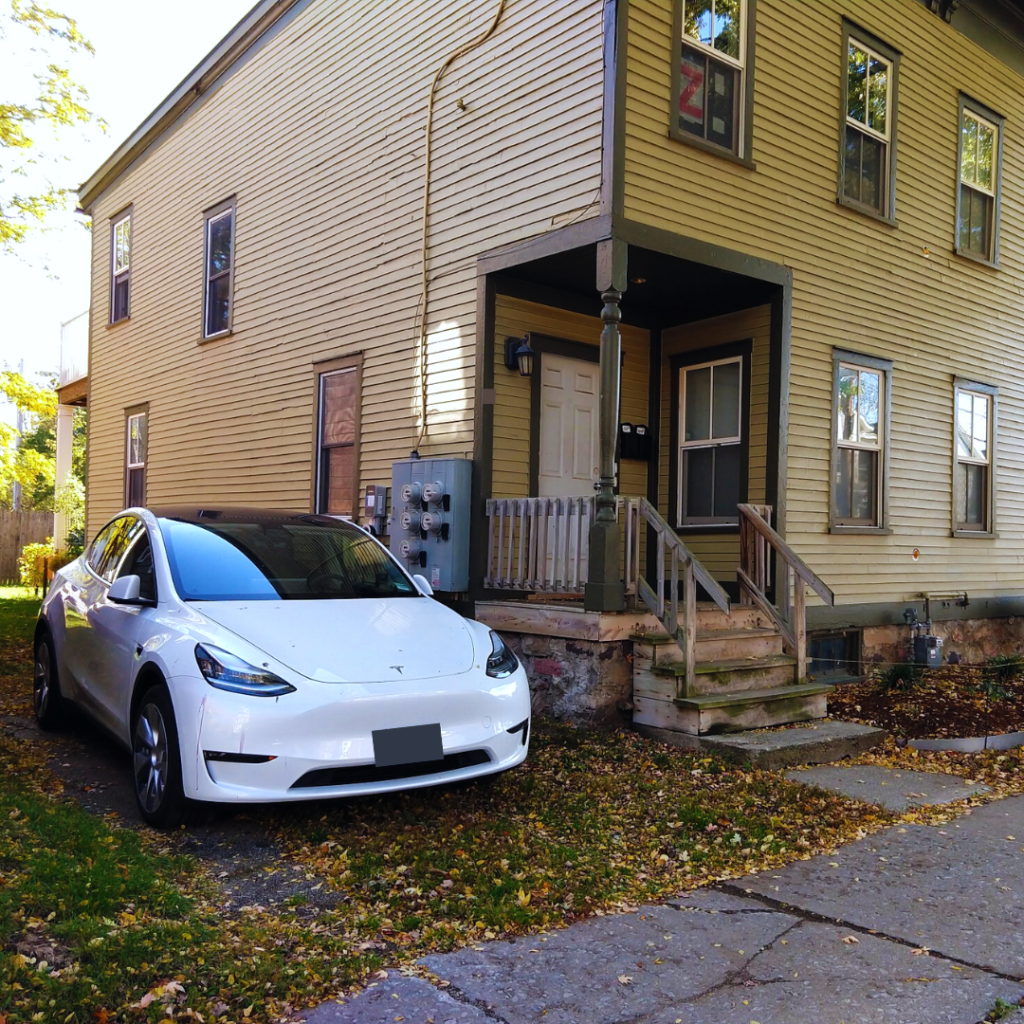 Electric vehicle parked next to house