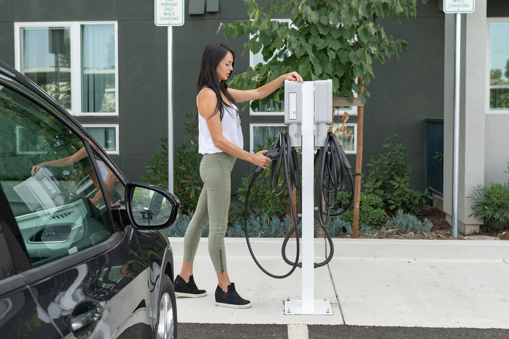 Driver plugging in at an EVmatch charging station