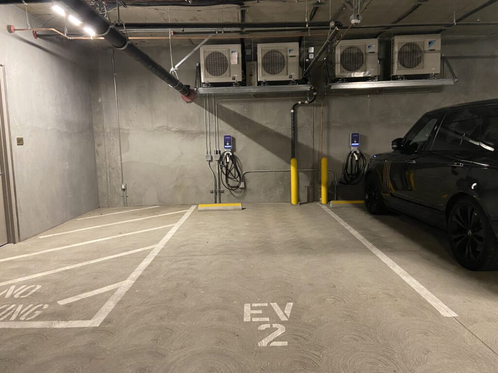 Shared EV charging stations at a condominium parking garage showcasing the success of EV charging for condos and townhouses